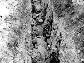 Soldiers hiding in a small trench in the Bois Bouver, 1916
