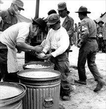 People are given rice in a U.N. camp during the Korean War, 1951