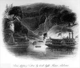 Esclaves chargeant le coton à la lumière de torches sur la rivière Alabama