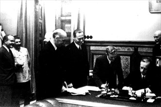 Signing of the Germano-Soviet Non-Agression Pact in Moscow. Ribbentrop signs. (Also seen: Stalin and Molotov)
