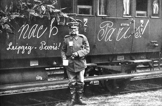 Soldier alongside of a train: 'To Paris!'