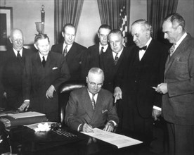 Marshall plan, President Truman signs the Economic Assistance Act, a program for the reconstruction of Europe. (Dean Acheson on the right) April 19, 1949