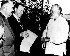 Ernest Hemingway, aged 56, welcoming reporters at the 'Villa', his house near Havana, where he lived after receiving the Nobel Prize for literature in 1956.