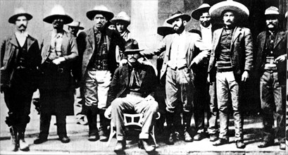 General Orozco, surrounded by members of his staff and other revolutionary comrades, in the makeshift campgrounds of those who were occupying Ciudad Juarez