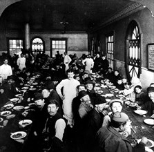 Immigrants eating in cafeteria just after their arrival