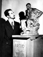 Sigmund Freud's son in front of a statue of his father