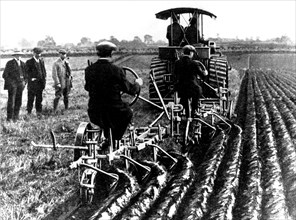 Machines revolutionating the agriculture: Two moldboard plows towed by a steam tractor