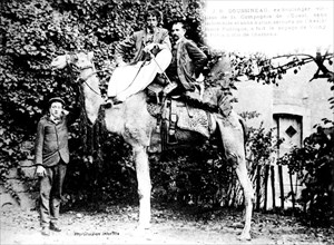 Postcard, J.B. Doussineau riding a camel