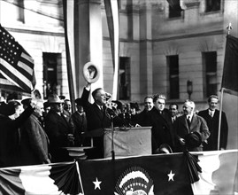 President Roosevelt delivering a speech in front of the crowd at Harisburg. He is accompanied by John Lewis