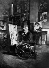 1914, Renoir painting in his wheelchair