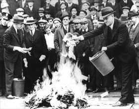 City council man, Mr. Barlow, and Treasury Secretary, Mr. Jil Martin, burning 100,000 dollars of "scrip money" (after the banks' closure)
