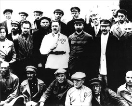Stalin surrounded by a group of revolutionaries