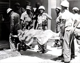 Landig at the Bay of Pigs. Members of the Cuban Red Cross going to a wounded mercenary's assistance
