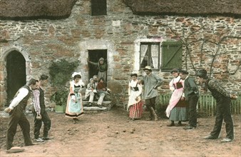 Postcard representing a bowls game in a farmyard