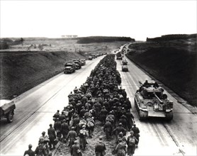 German prisoners on the highway near Giesen, escorted by the 3rd U.S. Army