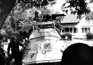 Katanga. U.N.O. forces in action in Elisabethville. The crew of a damaged armored vehicule fights back with submachine guns.