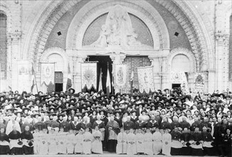Pilgrims posing in front of Notre Dame de Lourdes