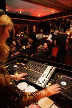 DJ woman mixing in a bar