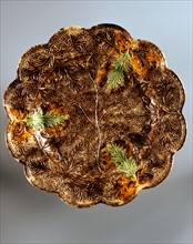 Dish with brown and green leaf motif and vine branch