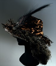 Black wire mesh hat covered in satin, crushed velvet, ostrich feathers and aigrettes