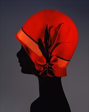 Red Lenci cloche hat with side flower motif
