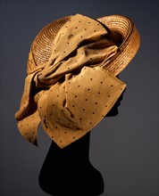 Natural straw hat with large mustard-coloured side bow
