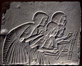 Fragment from funerary wall from Nineteenth dynasty: Group of scribes intently writing down a dictation