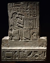 Small funerary stele with image of the deceased holding a lotus flower