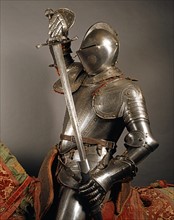 Soldier in armor pulling his sword