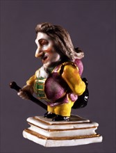 Grotesque character in painted ceramic