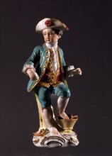 Figurine of a boy with a basket of vegetables.