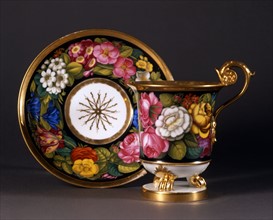 Cup and saucer with floral decoration.