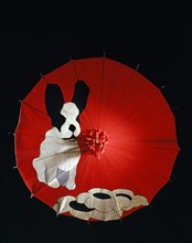 Red felt umbrella with a black and white dog