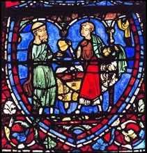 Parabole du fils prodigue : le père donne à son fils sa part d'héritage (vitrail de Chartres)