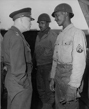 General Eisenhower chats with a black soldier  at Cherbourg (February 21,1945)