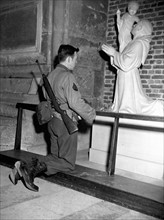 A U.S soldier pray in Cathedral Notre-Dame at Reims (France) Dec.25,1944.