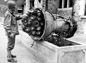 American soldier examines part of "V-2" in Belgium (fall 1944)