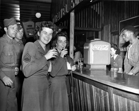 Membres du Corps d'armée de femmes  buvant un Coca-Cola à Paris (France) le 14 juillet 1945