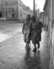 A French Moroccan soldier aids wounded comrade in Mulhouse area (November 23, 1944)