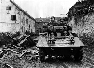 A U.S M-8 reconnaissance armored car in Kinzweiler(Germany) November 1944