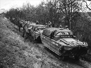 U.S amphibious trucks "Ducks" await to ferry soldiers across the Saar river into Germany (1944)