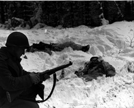 A U.S soldier stops to load the clip in his rifle Houffalize area (Belgium) January 15, 1945