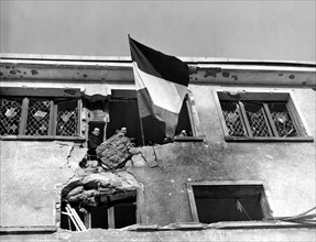 Happy people of Wiltz (Luxemburg) raises their flag  (January 22, 1945)