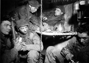 Battle-weary U.S. troops relax in Prum (Germany) February 12, 1945