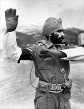 A Sikh tribesman directs traffic somewhere in Italy (March 27,1944)