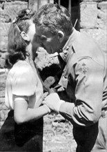 U.S Maj.Gen.Raymond O.Barton receives a kiss in France (Summer 1944)