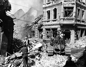 Un bulldozer américain déblaie les rues de Siegburg, en Allemagne. 
(1945)