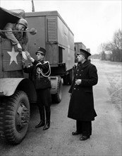 A U.S Army driver has his papers checked by a Dutch border guard near Reusel (Holland), March 21,1945