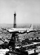 A C-54 Skymaster  wings past the Eiffel Tower in Paris, June 1945