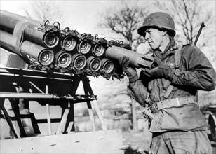 A U.S soldier loads a rocket shell into a launcher mouted on a jeep in the 7th U.S Army sector in  France, December 27,1944